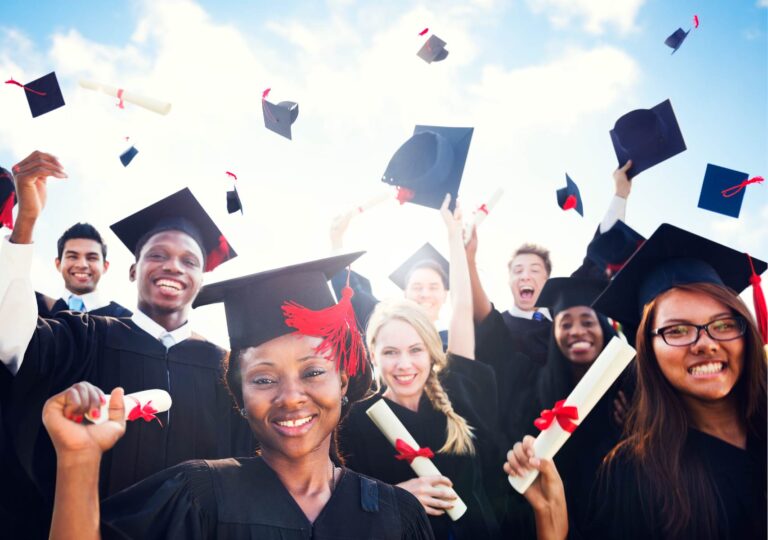 group of graduates with caps in air